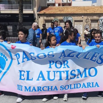 Marchantes llevando una pancarta de Pasos Azules por el Autismo