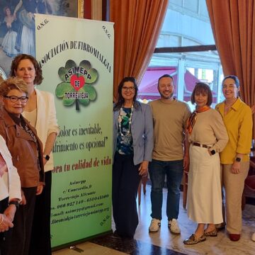Representantes de la asociación ASIMEPP y autoridades locales junto a un cartel informativo durante el inicio de las actividades por el Día Internacional de la Fibromialgia